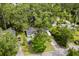An aerial view of a home surrounded by lush greenery, a small pool, and outdoor recreational features at 708 15Th Ave., Conway, SC 29526
