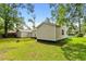 View of a well-maintained backyard with green lawn, outbuilding, and mature trees, offering space for outdoor activities at 708 15Th Ave., Conway, SC 29526