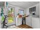 Bright laundry room with wooden floor, washer, dryer, storage, and an open view to the outdoors at 708 15Th Ave., Conway, SC 29526