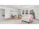 Bright living room with neutral palette, large windows, shelving, and comfortable seating at 7123 Shooting Star Way, Myrtle Beach, SC 29579