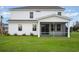 Back of a white house with a screened-in porch overlooking a large grass lawn at 7147 Shooting Star Way, Myrtle Beach, SC 29579