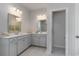 This bathroom features double vanities, bright lighting, and a walk-in shower for a spa-like experience at 7147 Shooting Star Way, Myrtle Beach, SC 29579