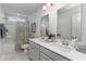 Bright bathroom featuring a double vanity, ample lighting, and shower and tub at 7147 Shooting Star Way, Myrtle Beach, SC 29579