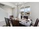 Dining room with a dark wood table, six chairs and a view of a new home being built at 7147 Shooting Star Way, Myrtle Beach, SC 29579