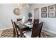 Dining room with a dark wood table, six chairs, modern chandelier and decor at 7147 Shooting Star Way, Myrtle Beach, SC 29579