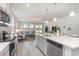 Kitchen open to the living room, features quartz countertop, and stainless steel appliances at 7147 Shooting Star Way, Myrtle Beach, SC 29579