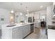 Open-concept kitchen with a quartz island and stainless steel dishwasher at 7147 Shooting Star Way, Myrtle Beach, SC 29579