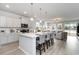 Open kitchen with gray cabinets, quartz countertop island, and stainless steel appliances at 7147 Shooting Star Way, Myrtle Beach, SC 29579