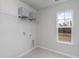 Bright laundry room with a window, storage shelf, and washer and dryer hookups at 7147 Shooting Star Way, Myrtle Beach, SC 29579
