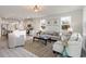 Inviting open concept living area with large windows, modern decor, and seamless flow into the kitchen at 7147 Shooting Star Way, Myrtle Beach, SC 29579