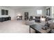 Comfortable living room featuring a gray sectional sofa, patterned ottoman, and neutral carpet at 7147 Shooting Star Way, Myrtle Beach, SC 29579