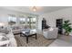 Bright living room boasts neutral tones, stylish furniture, and natural light with a view of the water at 7147 Shooting Star Way, Myrtle Beach, SC 29579