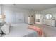 This main bedroom boasts a relaxing ambiance, with soft colors, plush carpet, and ensuite bathroom access at 7147 Shooting Star Way, Myrtle Beach, SC 29579