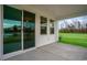 Patio with sliding glass doors, overlooking the green lawn and trees at 7147 Shooting Star Way, Myrtle Beach, SC 29579