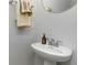 This powder room features a stylish pedestal sink, round mirror, and towel bar, adding a touch of elegance at 7147 Shooting Star Way, Myrtle Beach, SC 29579