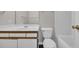 Well-lit bathroom featuring vanity with white sink, toilet, and tub at 8658 Southbridge Dr. # L, Myrtle Beach, SC 29575