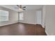 Bedroom with wood floors, a ceiling fan, and sunny window views at 8658 Southbridge Dr. # L, Myrtle Beach, SC 29575