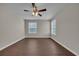 Cozy bedroom with hardwood floors, ceiling fan, and bright window views at 8658 Southbridge Dr. # L, Myrtle Beach, SC 29575