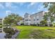 Exterior of property featuring well maintained landscaping and pond at 8658 Southbridge Dr. # L, Myrtle Beach, SC 29575