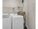 Bright laundry room with modern appliances, shelving and water heater at 8658 Southbridge Dr. # L, Myrtle Beach, SC 29575