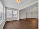 Large living room with hardwood floors and a sunny bay window nook at 8658 Southbridge Dr. # L, Myrtle Beach, SC 29575