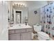 Bright bathroom featuring a vanity with a large mirror and a shower with a themed curtain at 876 Palmetto Trail # 103, Myrtle Beach, SC 29577