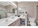 Bright bathroom featuring dual sinks, a large mirror, and a glass-enclosed shower at 876 Palmetto Trail # 103, Myrtle Beach, SC 29577