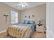 Cozy bedroom with a double bed, neutral walls, and a window with plantation shutters allowing natural light at 876 Palmetto Trail # 103, Myrtle Beach, SC 29577