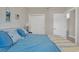 Bedroom showcasing a bed with a vibrant blue comforter, alongside closet doors and a glimpse into the hallway at 876 Palmetto Trail # 103, Myrtle Beach, SC 29577