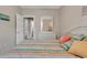 Cozy bedroom showcases colorful striped bedding, a dresser with mirror, and an open doorway at 876 Palmetto Trail # 103, Myrtle Beach, SC 29577