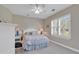 Cozy bedroom with a ceiling fan, neutral tones, and a window providing natural light at 876 Palmetto Trail # 103, Myrtle Beach, SC 29577