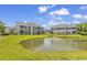 Beautiful condo buildings sit around a picturesque pond with a fountain and green lawn at 876 Palmetto Trail # 103, Myrtle Beach, SC 29577