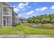 Beautiful condo buildings overlooking a tranquil pond with fountain and lush landscaping at 876 Palmetto Trail # 103, Myrtle Beach, SC 29577