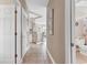 Bright hallway with tiled floor, white doors, and opening leading into the kitchen and living area at 876 Palmetto Trail # 103, Myrtle Beach, SC 29577