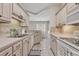 Functional kitchen with tile backsplash and a view into the dining area at 876 Palmetto Trail # 103, Myrtle Beach, SC 29577
