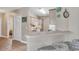 Open-concept kitchen features a breakfast bar, bright cabinets, and updated appliances at 876 Palmetto Trail # 103, Myrtle Beach, SC 29577