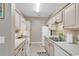 Well-equipped kitchen boasting tiled floor, neutral cabinets and modern white appliances at 876 Palmetto Trail # 103, Myrtle Beach, SC 29577