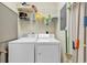 Functional laundry area equipped with a washer, dryer, and storage shelves for household supplies at 876 Palmetto Trail # 103, Myrtle Beach, SC 29577
