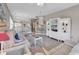 Bright living room with beachy decor, opening to the dining area and featuring a modern entertainment center at 876 Palmetto Trail # 103, Myrtle Beach, SC 29577
