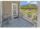Relaxing screened-in patio with seating overlooking a serene pond and lush greenery at 876 Palmetto Trail # 103, Myrtle Beach, SC 29577