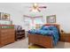 Cozy bedroom with a wood bed frame and a ceiling fan at 8861 Chandler Dr. # F, Surfside Beach, SC 29575