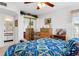 Bright bedroom with a wood bed frame, ceiling fan, and a glimpse of the en-suite bathroom at 8861 Chandler Dr. # F, Surfside Beach, SC 29575