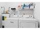 Laundry area showcasing the washer, dryer, and storage shelf at 8861 Chandler Dr. # F, Surfside Beach, SC 29575
