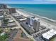 Coastal view of a multi-story resort with parking and oceanfront access on a sunny day at 9550 Shore Dr. # 1430, Myrtle Beach, SC 29572