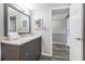 Bathroom features granite countertop vanity, next to an open door to a bedroom at 9550 Shore Dr. # 1430, Myrtle Beach, SC 29572