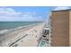 Expansive view of beach with rows of umbrellas in the sand and a turquoise ocean at 9550 Shore Dr. # 1430, Myrtle Beach, SC 29572