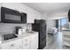 Efficient kitchen features white cabinets and appliances, maximizing space and convenience at 9550 Shore Dr. # 1430, Myrtle Beach, SC 29572