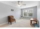 This bedroom has a chair with a decorative pillow, a ceiling fan, and two windows at 100 Culpepper Way # 1003, Myrtle Beach, SC 29579