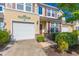 Charming two-story townhome with a well-manicured lawn, attached garage, and inviting front entrance at 100 Culpepper Way # 1003, Myrtle Beach, SC 29579