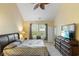 This main bedroom features a ceiling fan, a dresser with a mirror, and an exterior view at 100 Culpepper Way # 1003, Myrtle Beach, SC 29579